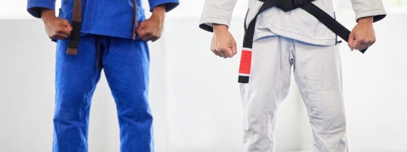 Karate, uniform and men in dojo, uniform and start training, exercise and workout with commitment a.